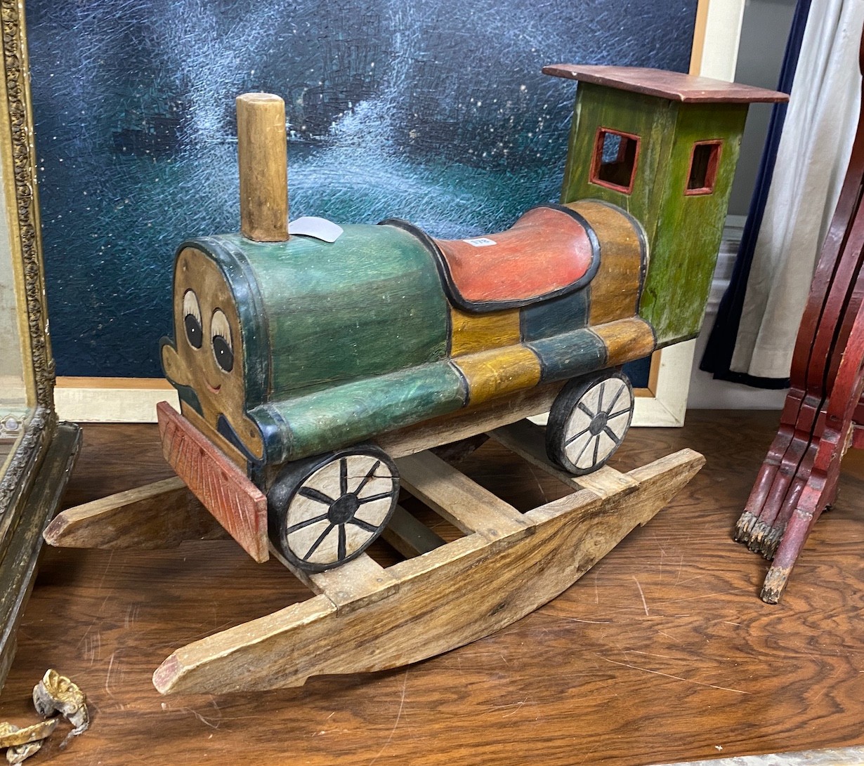 A child's carved wood rocking locomotive, length 80cm, height 59cm